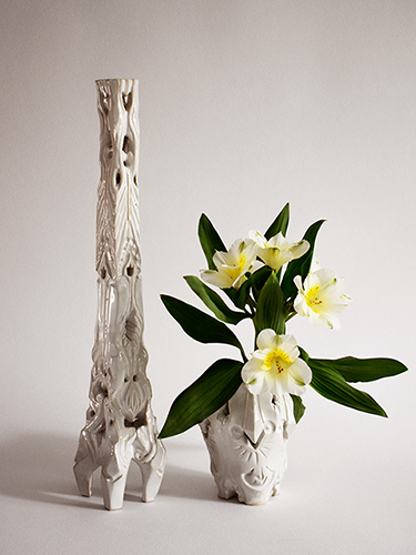  Ceramics Candlestick and decorative ceramic vase with flowers, both white glazed.