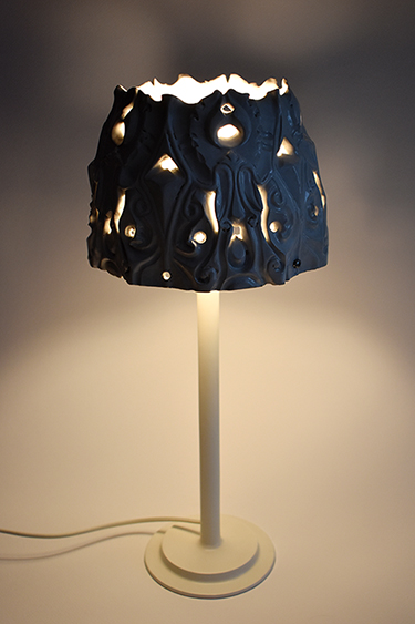 White glazed decorative ceramic lamp, when the light is on.